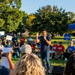 Casey Askar energizing supporters at a vibrant campaign rally, showcasing community engagement and a hopeful atmosphere.